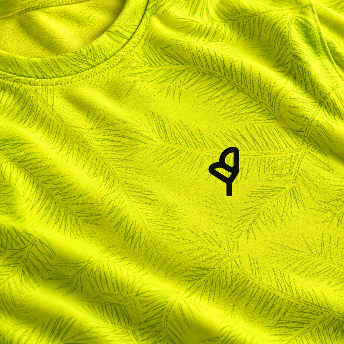 YUL Neon Radioactive Pine men's running shirt, neon yellow, close-up of the chest emblem.