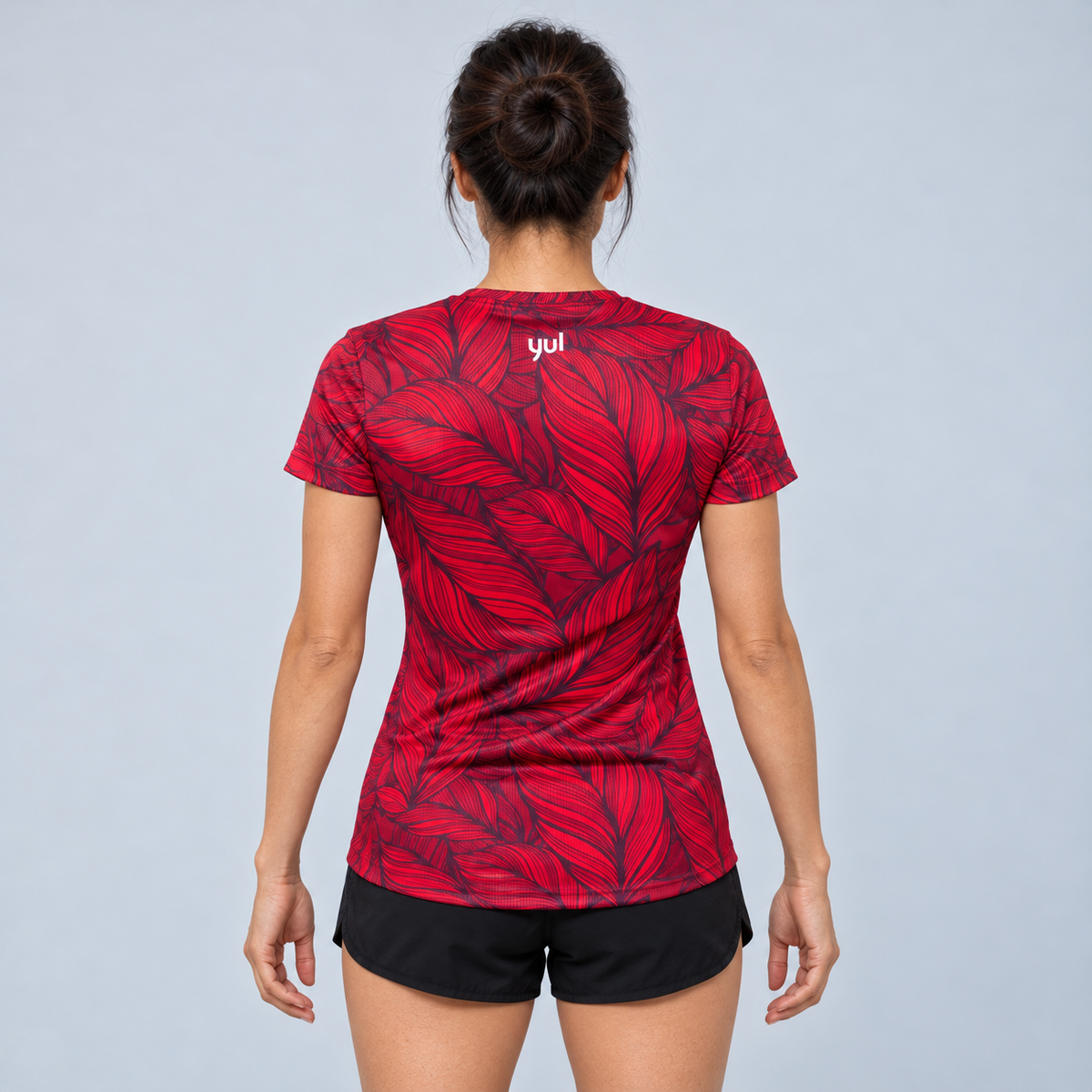 YUL Crimson Red women's running shirt, red and black, back studio view.